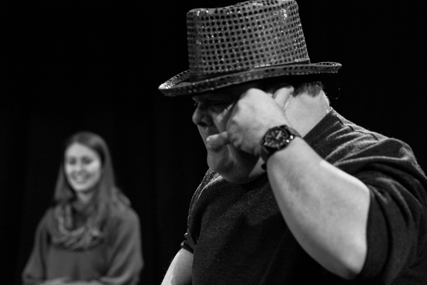 Black and white photo of Graham with a sequined top hat and imaginary telephone